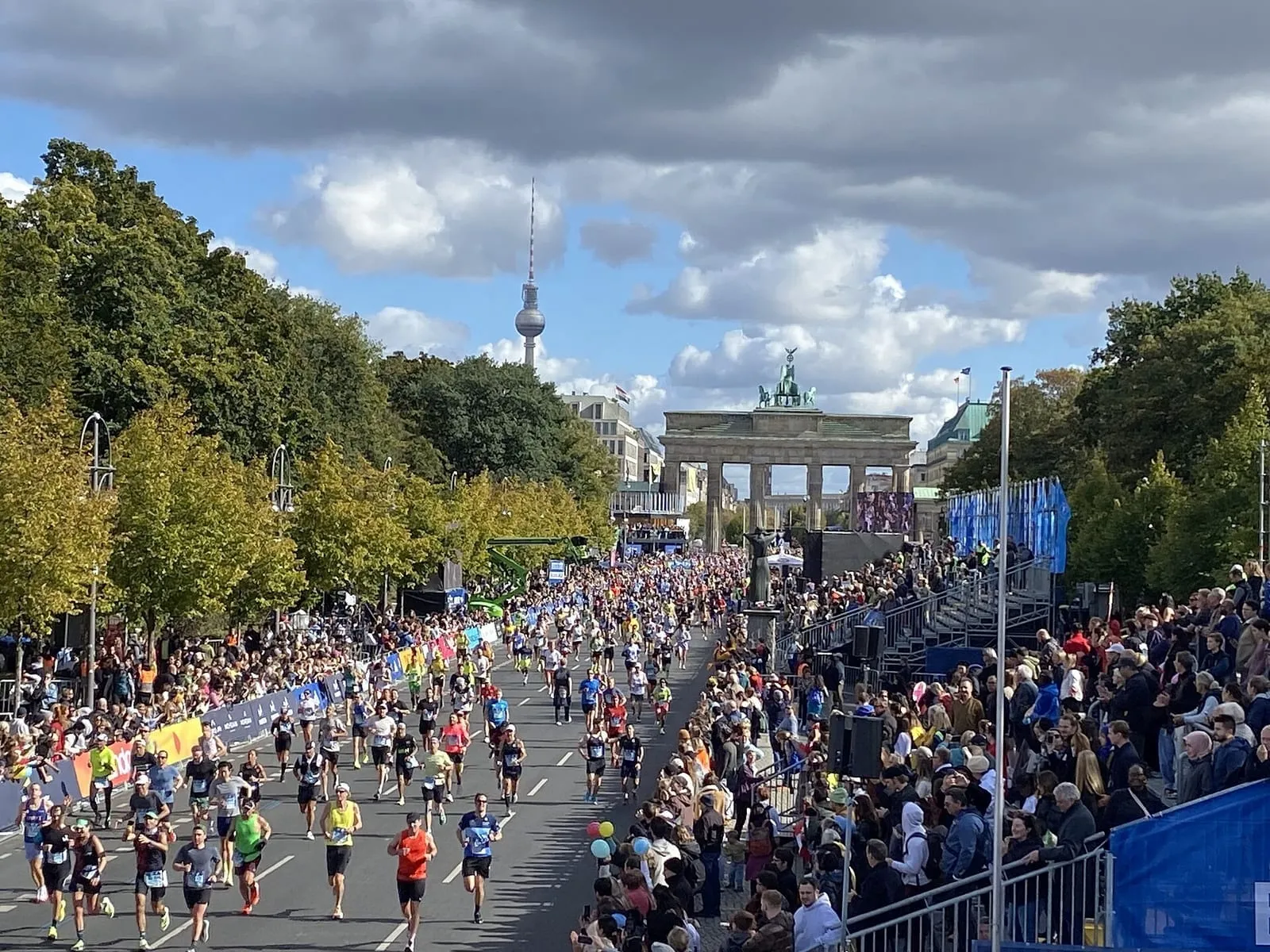 Des coureurs du marathon de Berlin sur la Straße des 17. Juni, la porte de Brandebourg en toile de fond
